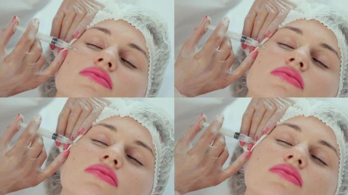 现代美容诊所美容注射程序的特写。用注射器注射入女性脸颊。美容师在美容院进行中胚层疗法和面部提升治疗。