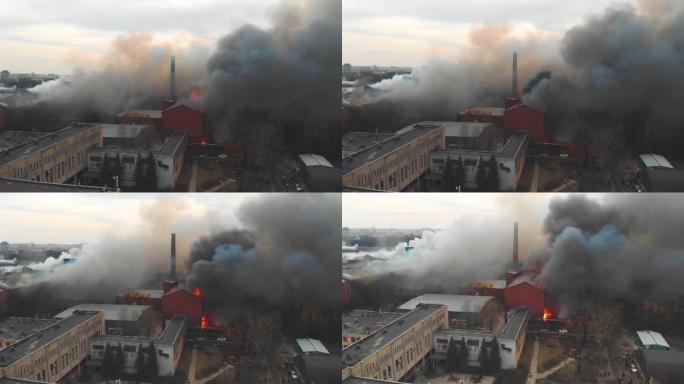 城市发生大规模大火，空中无人机俯视图砖厂大楼着火，地狱火爆炸火焰爆炸，有消防员队伍，纵火，烧毁破坏