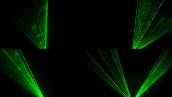 黑色工作室背景上的激光霓虹灯的动态绿色光束在烟雾中旋转。舞台全息图的展示。假日和派对的照明设备和效果