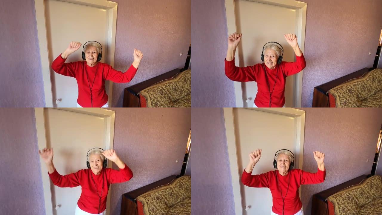 快乐的微笑搞笑的高级女人戴着耳机在家里用手机跳舞