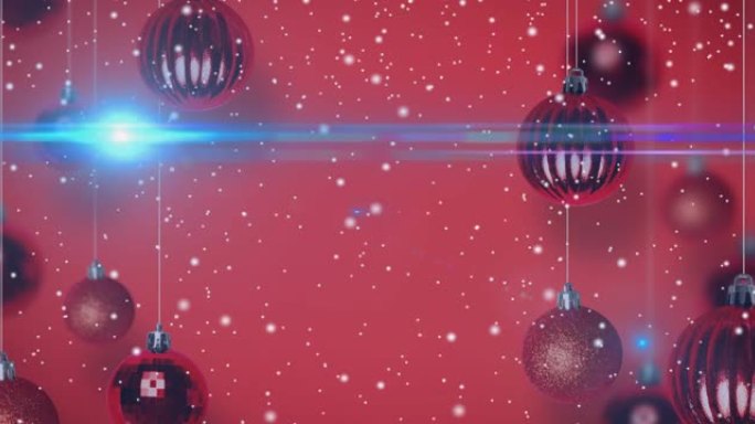 红色背景上的圣诞节小玩意上的雪的动画