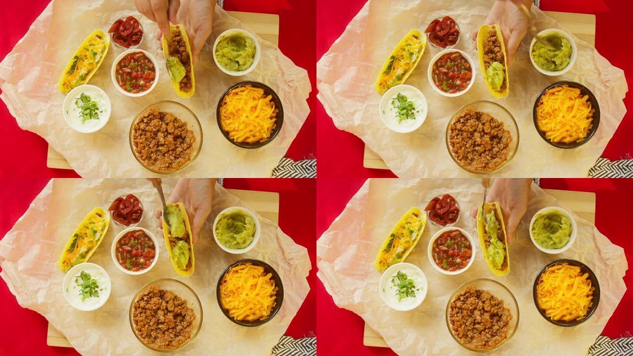 餐桌上的传统墨西哥食物，德克萨斯墨西哥美食。烹饪肉玉米卷或墨西哥卷饼，加入鳄梨色拉酱。番茄汤配玉米和