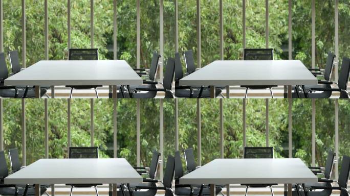 办公室会议室没有人空着，生态绿色自然。股东团队会议室办公室。白色木质桌子黑色椅子家具绿色背景。