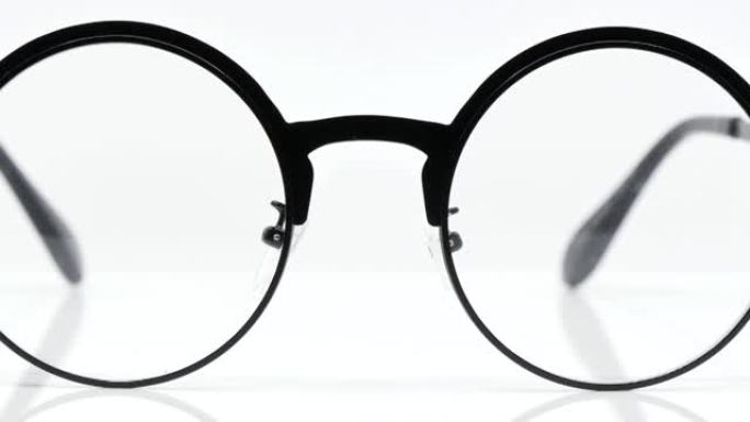 白色背景上的圆形黑色眼镜，黑色眼镜圆形运动圆形-4k 3840 × 2160，360度旋转。