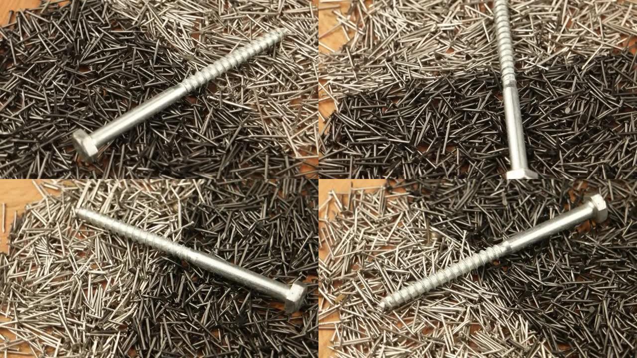 大金属螺丝在一堆各种形式的小钉子上