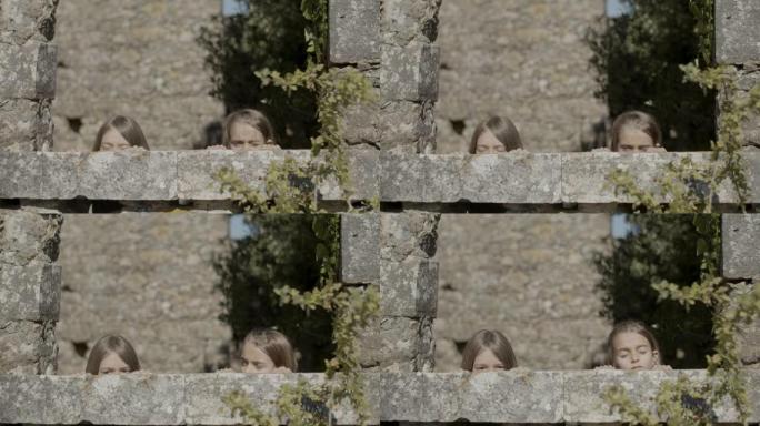 青少年从堡垒石墙窥探的手持镜头