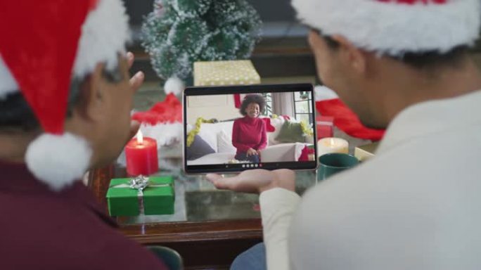 混血儿父子挥舞并使用平板电脑与屏幕上的幸福女人进行圣诞节视频通话