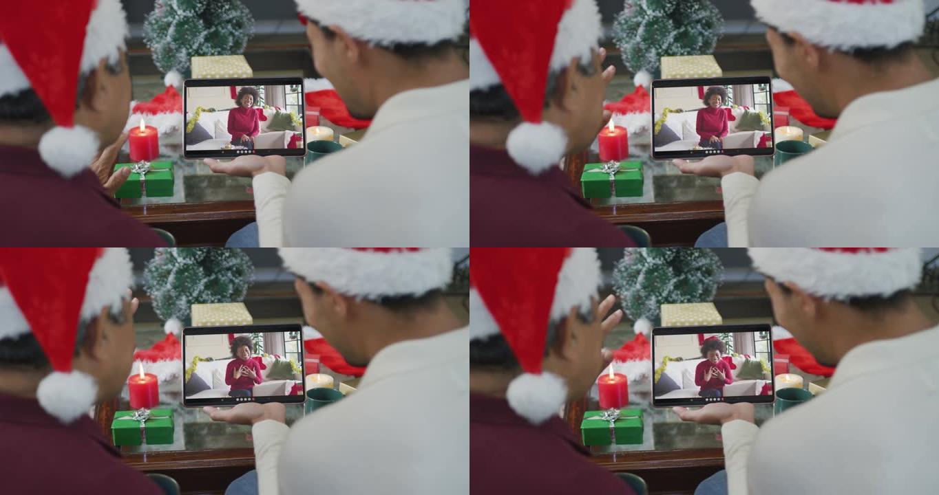 混血儿父子挥舞并使用平板电脑与屏幕上的幸福女人进行圣诞节视频通话