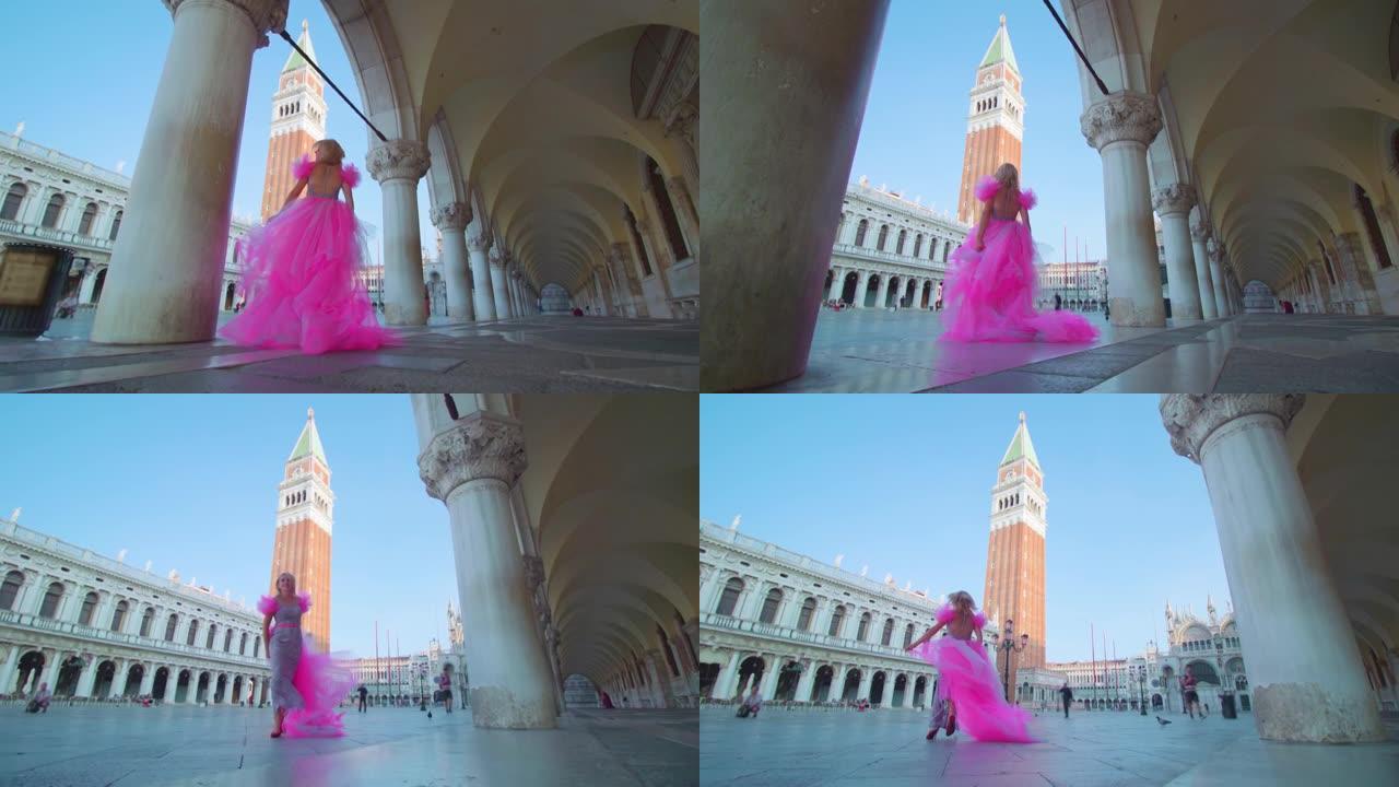 威尼斯圣马可广场穿着粉色优雅连衣裙的女孩
