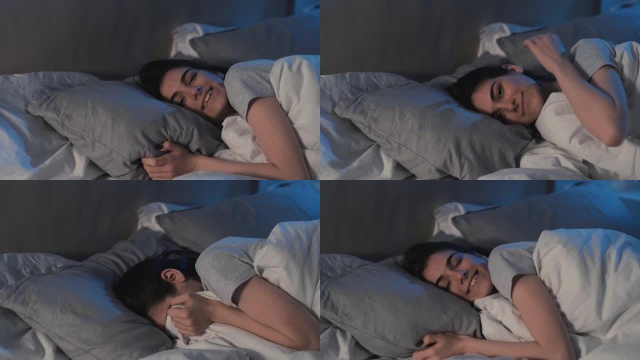 舒适的卧室睡眠女人拥抱在柔软的毯子