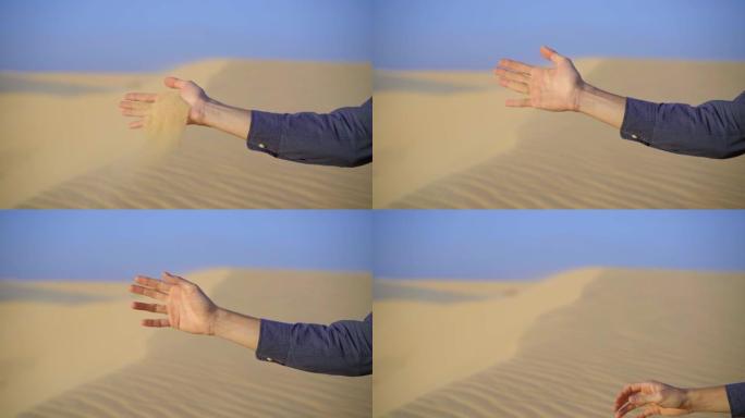 从男人的手中倒出的沙子的慢镜头
