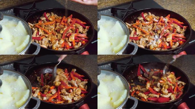 切成薄片的蔬菜，洋葱，甜椒和肉在油中油炸