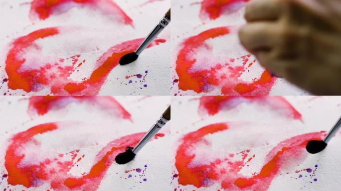 女艺术家的手的特写镜头用水彩画了一颗红色的心。4K