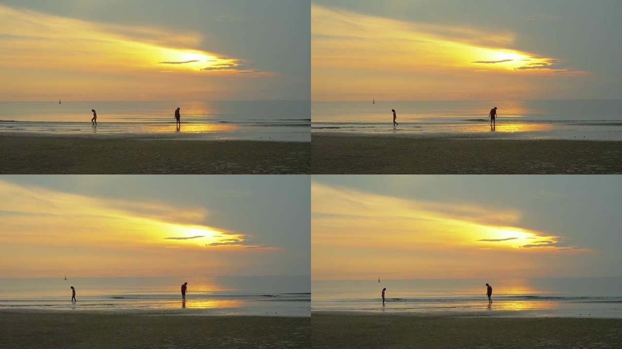 剪影儿童早上在海滩上放松，一起日出，生活方式理念。