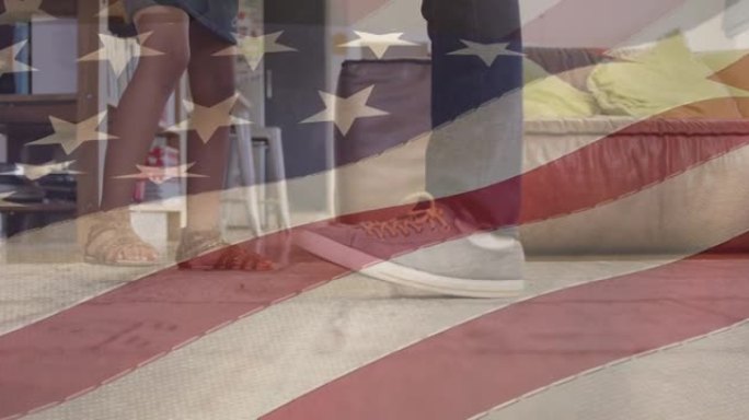 美国国旗在非洲裔美国人父亲与女儿跳舞的脚上飘扬的动画
