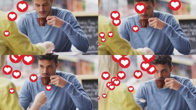 心脏图标的动画漂浮在快乐的高加索夫妇交谈和喝咖啡