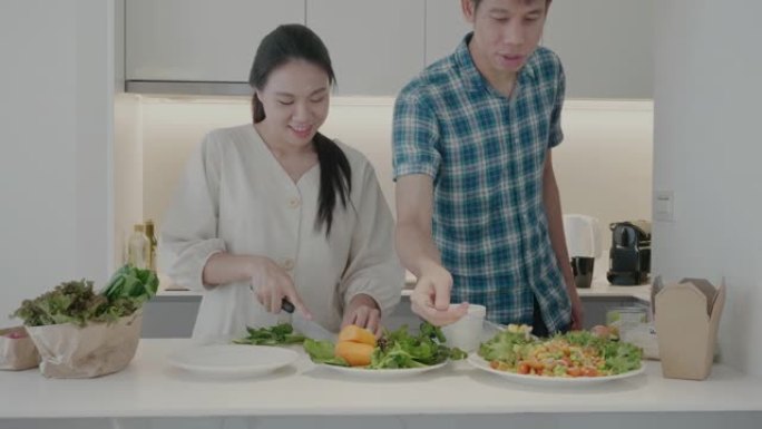东南亚夫妇在家庭厨房里吃纯素食
