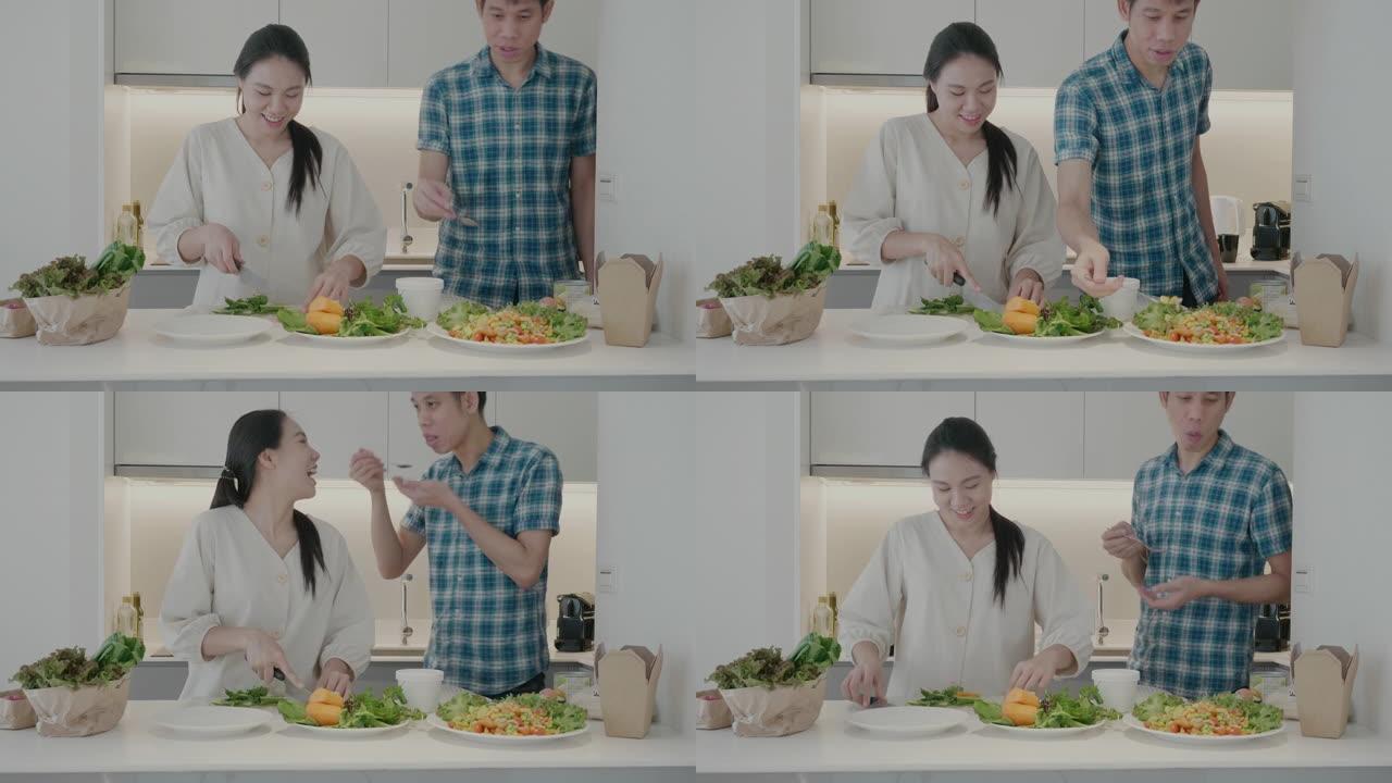 东南亚夫妇在家庭厨房里吃纯素食