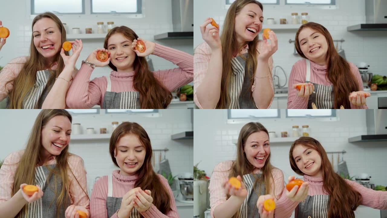女人和少女用橙色或胡萝卜闭上眼睛。母亲在厨房准备食物时与女儿玩耍