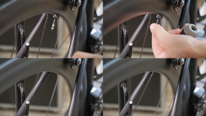 男性自行车技术员使用自行车泵将空气泵入轮胎后，从自行车轮胎上拧上盖子。自行车维修。修理自行车车间