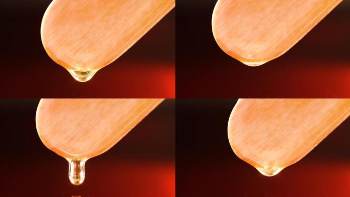 木架慢动作4k电影中清晰的黄褐色液体滴落