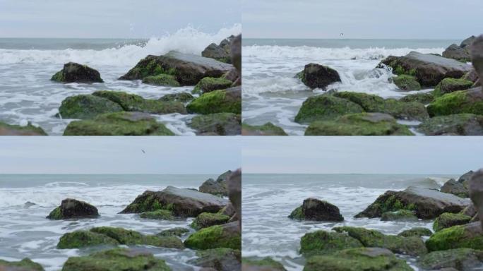 阴天的海景，海浪在巨石上震撼