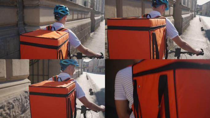 年轻的送货员在城市里用自行车送菜的后视图