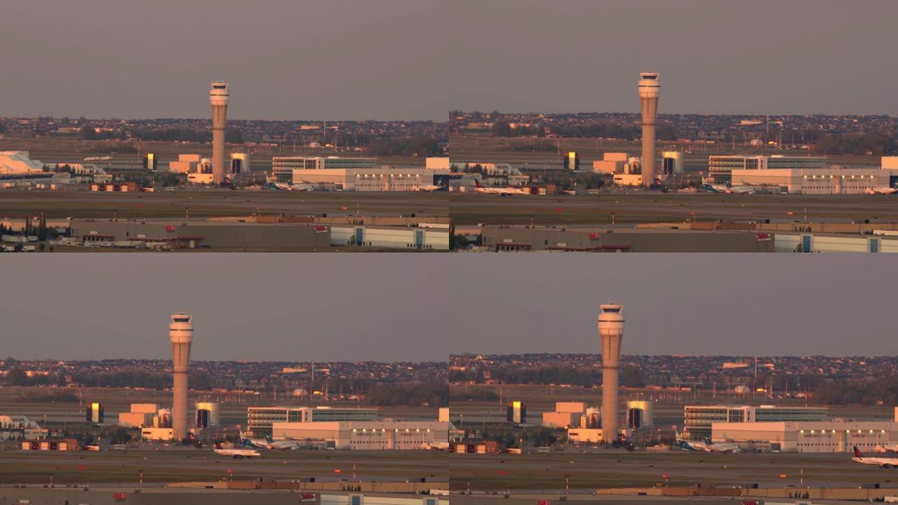 卡尔加里国际机场控制塔，下午有移动的飞机，鸟儿飞来飞去。