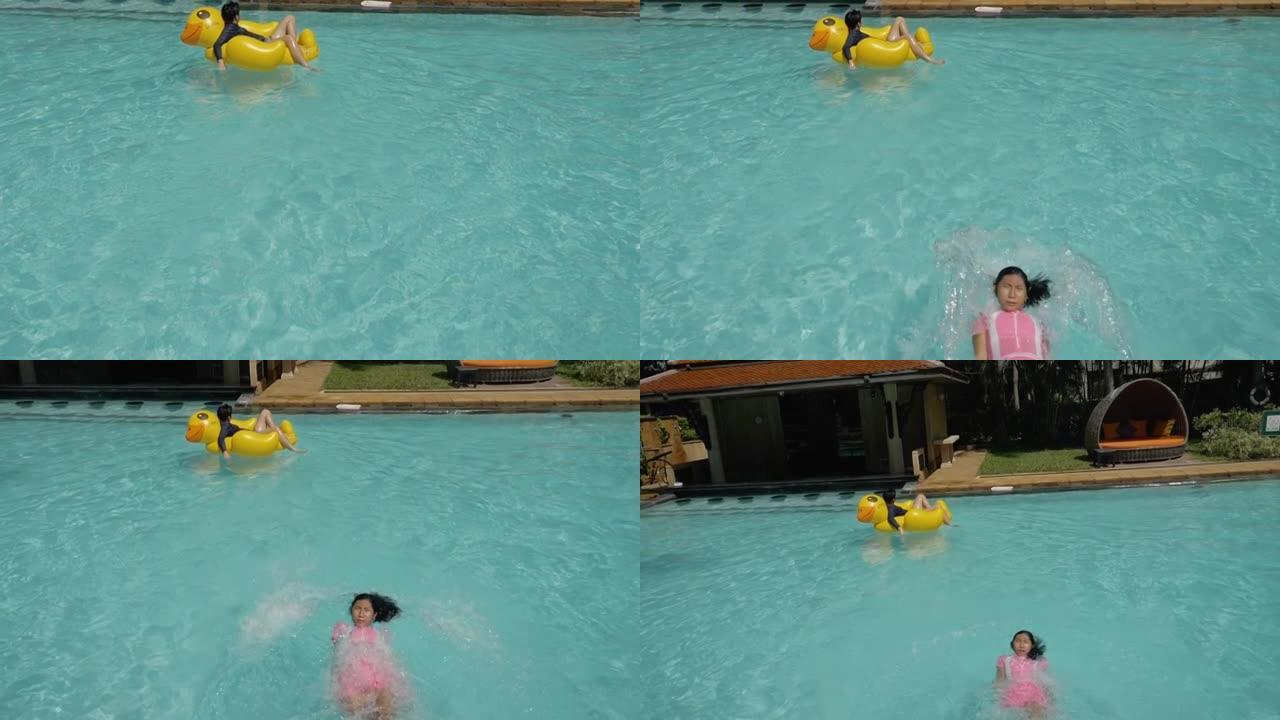 快乐的亚洲男孩在游泳池里的黄鸭橡皮筏上放松，女孩在假期和家人一起漂浮，生活方式理念。