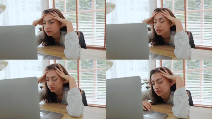 女人厌倦了工作，没有灵感懒惰冷漠地看着笔记本电脑
