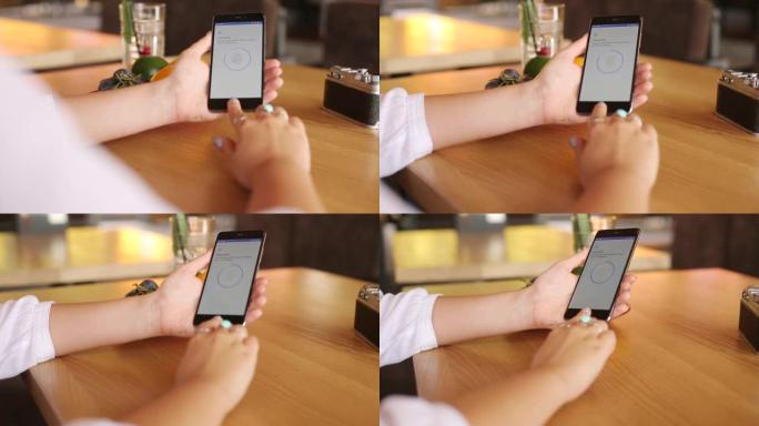 女性在智能手机上设置指纹，以确保安全登录和隐私。女人用生物识别传感器和手指解锁手机。女性曲调手机上的