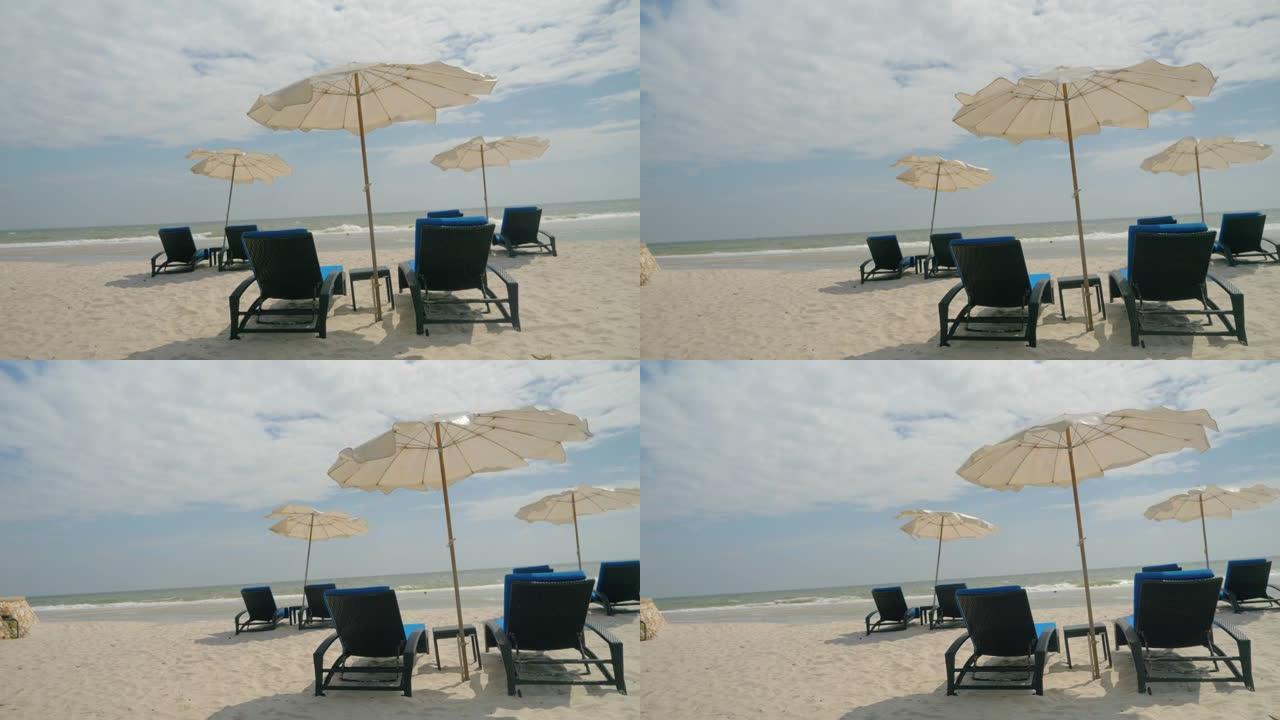 泰国华欣白色沙滩上的遮阳伞沙滩椅。