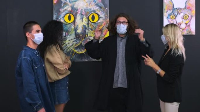 戴着口罩的人正在美术画廊的向导下观看展览