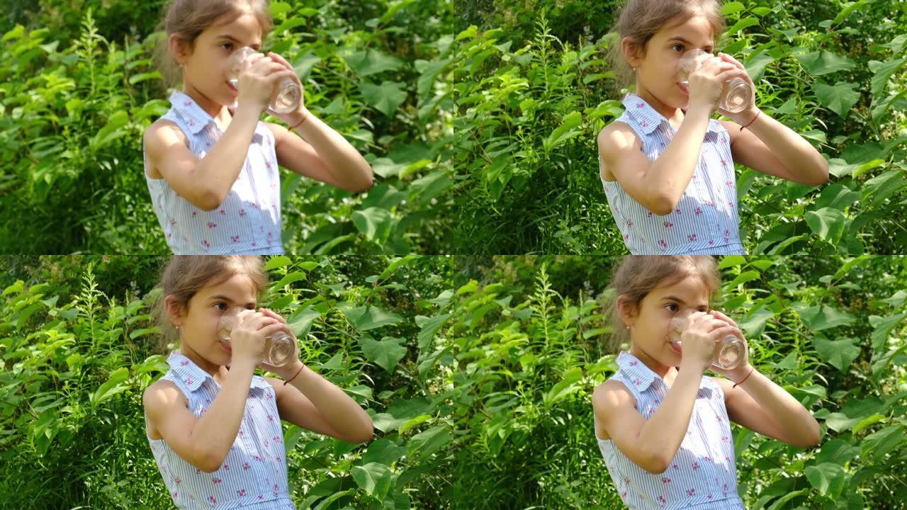 小女孩从杯子里喝水。选择性聚焦。