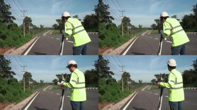 在阳光明媚的日子里，道路背景是经纬仪在公路上的测量员工程师。