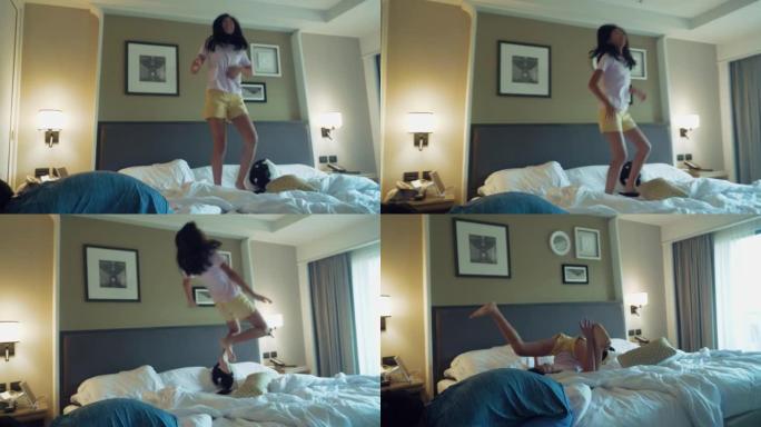 微笑的亚洲女孩在假期跳到酒店的床上，生活方式的概念。