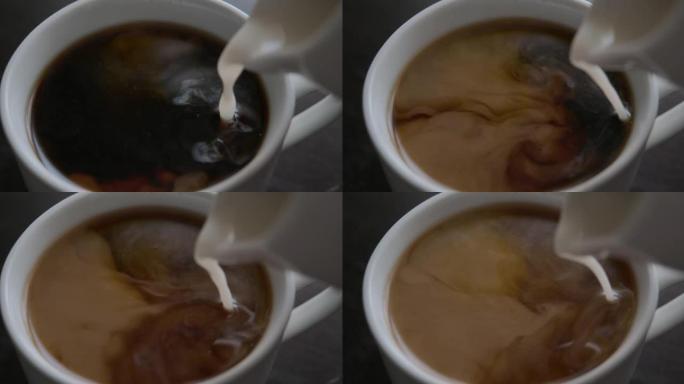 慢动作将黑咖啡倒入杯中。新鲜的早晨倒在红茶上特写。选择性聚焦。慢动作俯视图将牛奶倒入一杯热咖啡或茶中