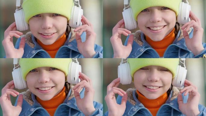 十几岁的女孩在户外通过无线耳机和在线智能手机应用程序听音乐