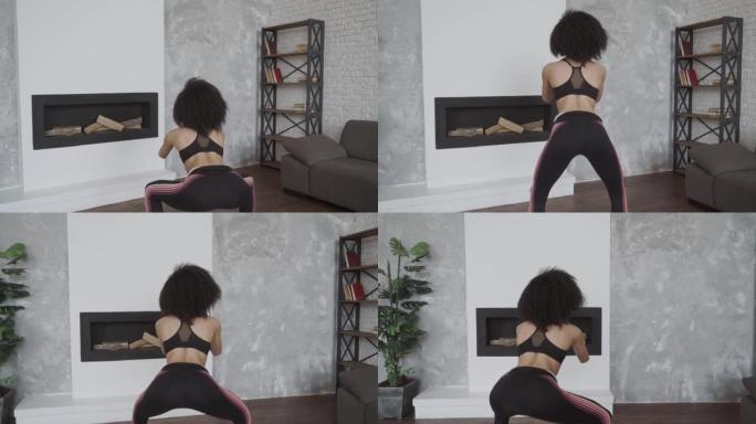健康的生活方式。愉快的运动女人穿着运动服在客厅里蹲下