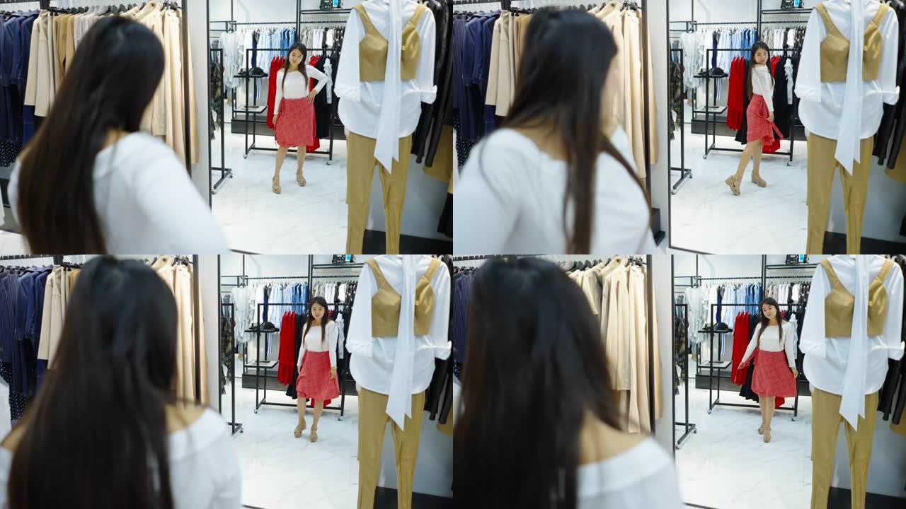 亚洲女性在时装店的镜子里看着自己