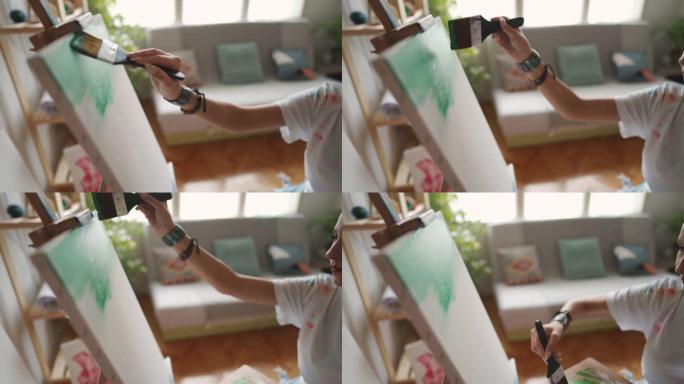 B-用宽画笔在画布上无法识别的女性艺术家绘画的B卷