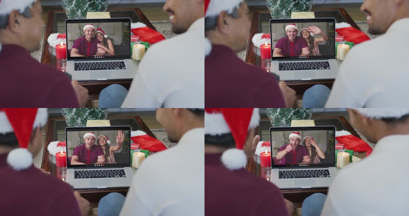 微笑的混血儿父子使用笔记本电脑与屏幕上的情侣进行圣诞节视频通话
