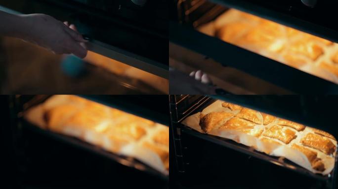 在烤盘上撒上芝麻的美味酥脆酥皮馅饼，上面铺有烘烤羊皮纸。烹饪烘焙的过程。