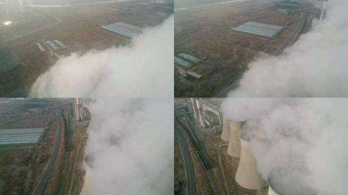工业区管道的空中轨道视图倾泻着浓浓的白烟。浓烟。火电厂管道，空气污染。