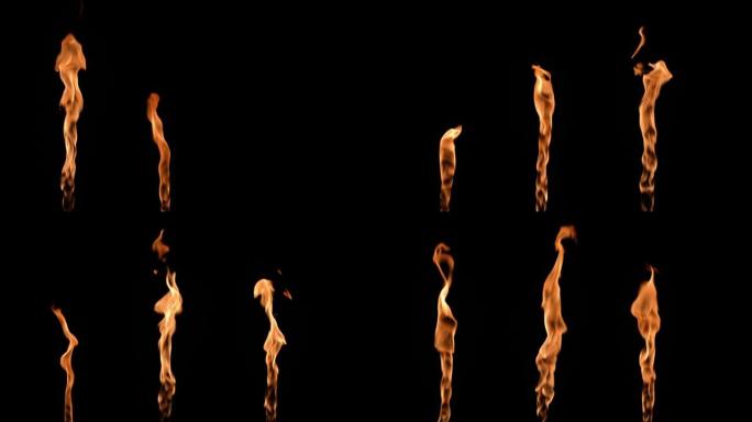 三个火焰交替点亮，并在黑色背景下发出橙黄色的火焰。真正的篝火、燃烧器或火炬在黑暗中燃烧起来。火光，危