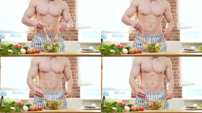 无法辨认的近距离肖像。英俊的健美男子赤裸着身体在家里的厨房里拌青菜沙拉。