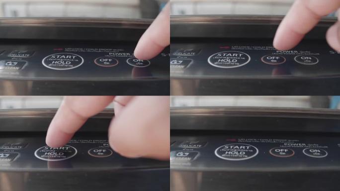 洗衣机上的特写手按和启动按钮