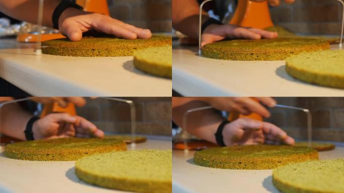 面包师的手将菠菜饼干切成小刀切片机。