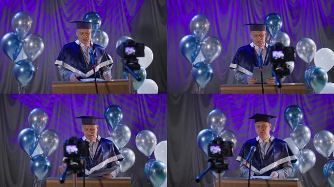 在线毕业，男院长办公室进行庄严的部分祝贺学生通过视频链接从大学毕业，由于气球的检疫和流行病的背景