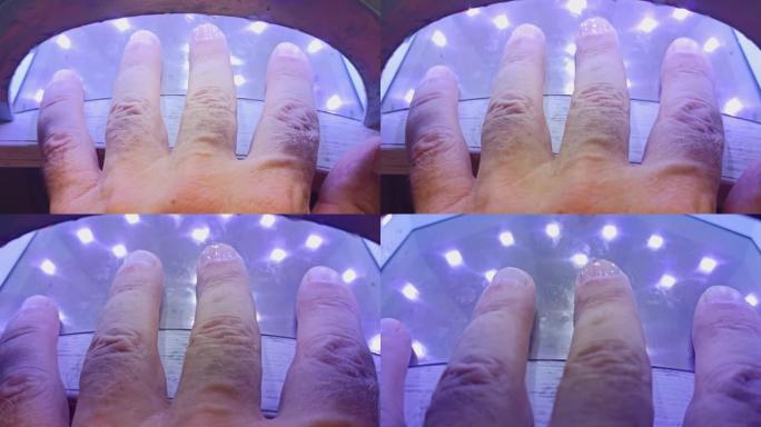 指甲上涂抹的凝胶在灯下干燥